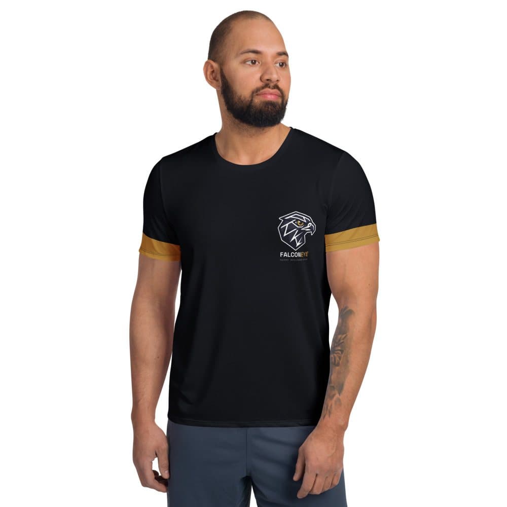 Front of the black FalconEye Performance Tee on a model: small falcon logo on the left chest with the FALCON in white and EYE in gold wordmark and FACEOFF INTELLIGENCE SYSTEM beneath it, with gold bands at both sleeve hems